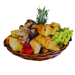 Large gift basket with seasonal fruit, pastries, chocolates, fresh flowers and greenery