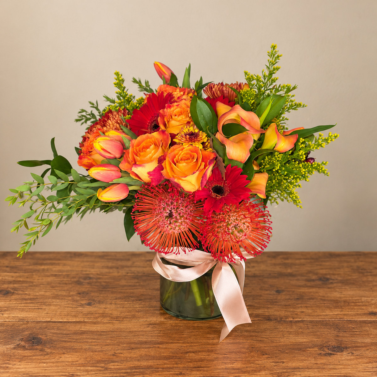 Large fall anniversary arrangement with mini callas, pincushion proteas, vine pumpkins, and gerberas